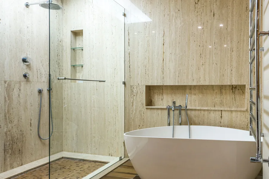 Travertine-clad bathroom with a freestanding bath